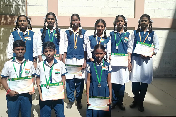 Students holding medal and certificates